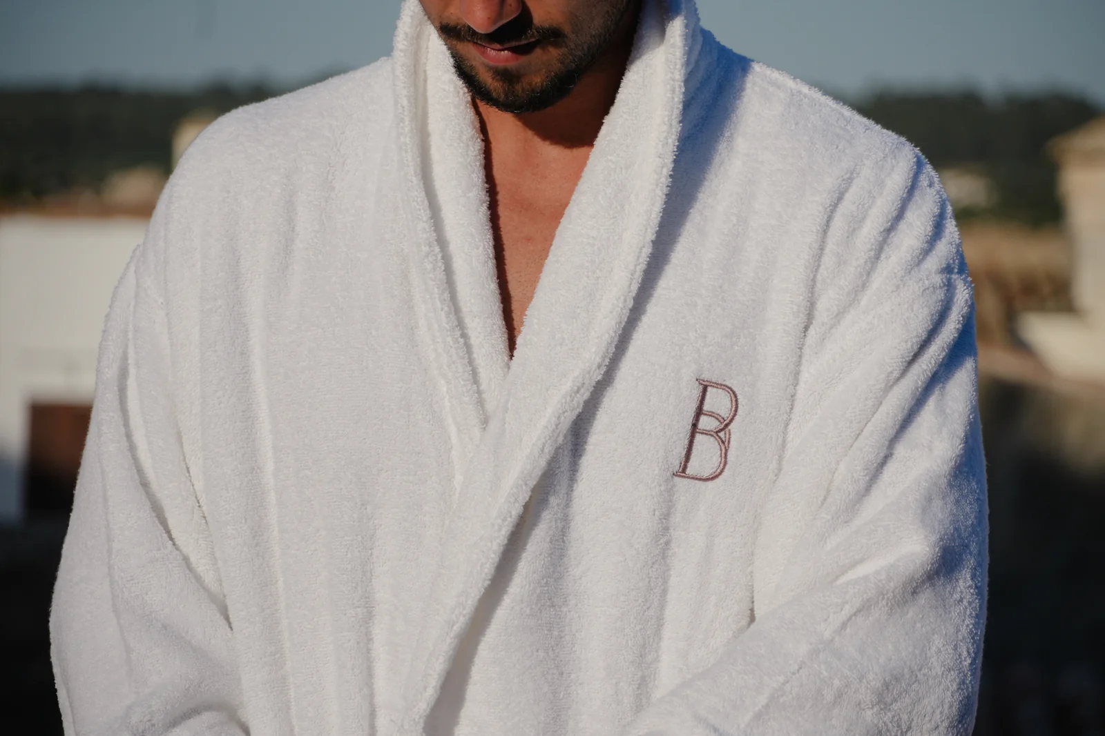 Guest in a BYTRA bathrobe on the rooftop